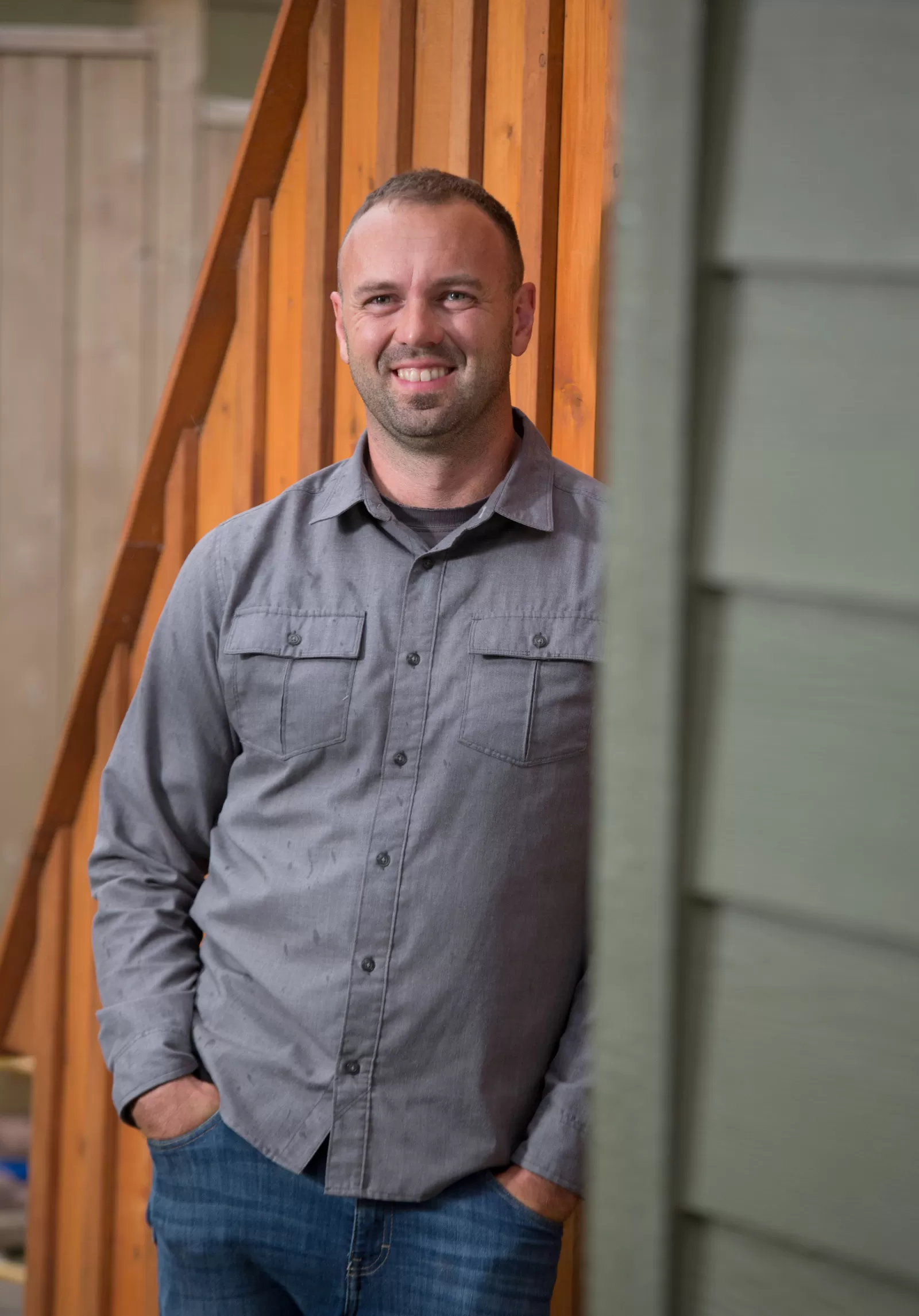 Rob Avis leaning against the corner of the house.